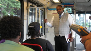 COO Ron Forrest talking to riders on a MetroLink train